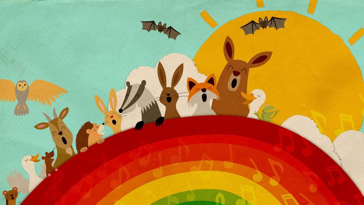 woodland animals singing behind a rainbow