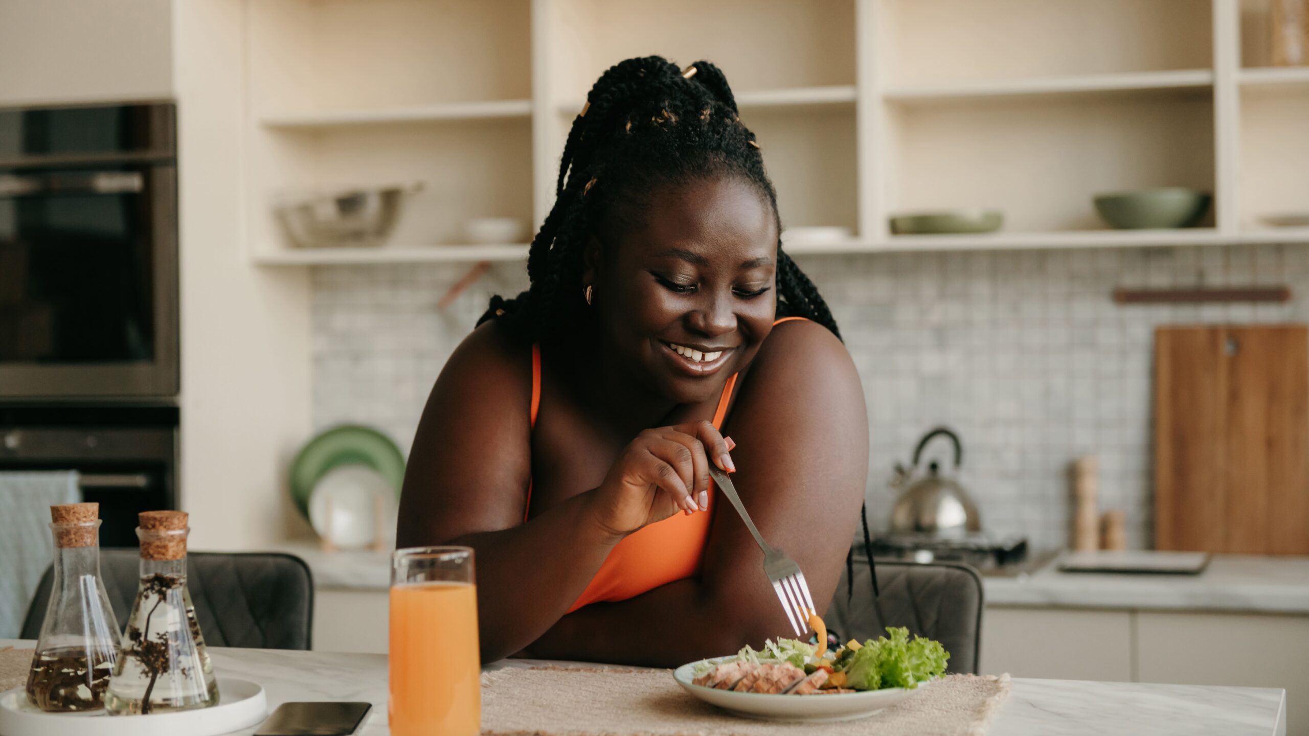 Smiling woman eating a salad