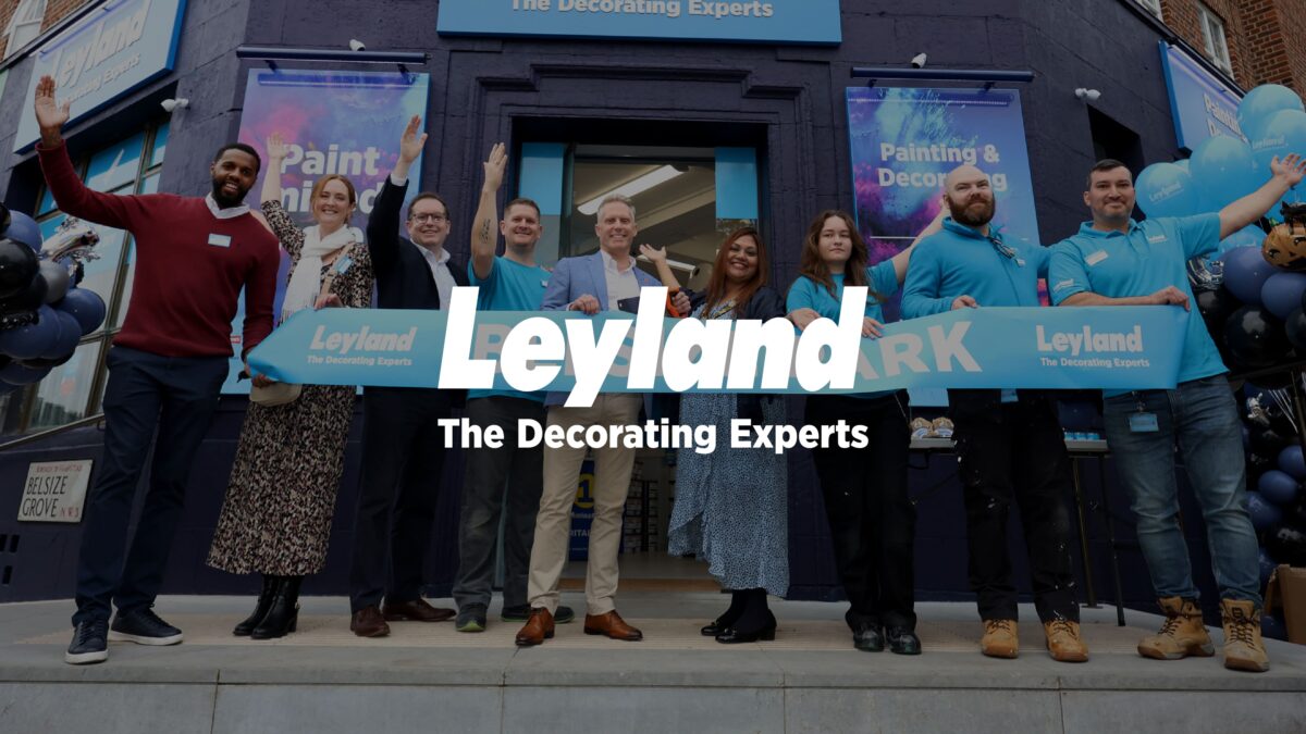 Leyland logo over an image of smiling Leyland staff outside a new store opening
