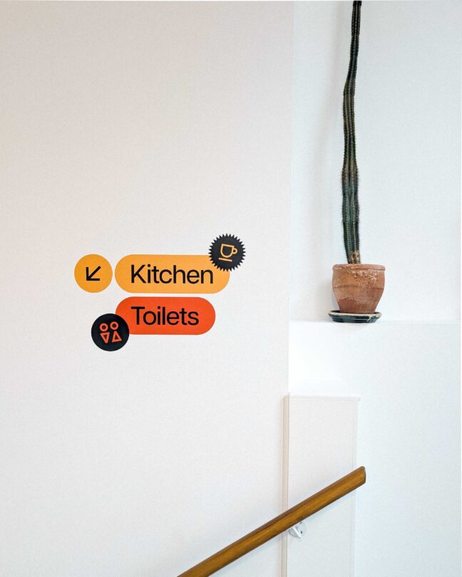 Signage in the Arch Studio pointing downstairs to our kitchen and toilets